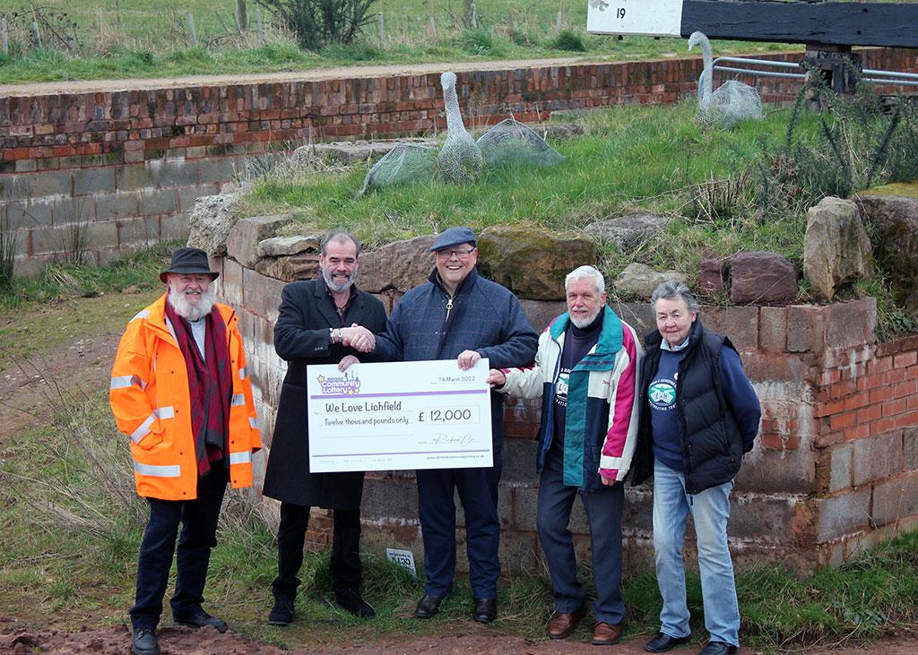 Simon Price of We Love Lichfield receives a cheque from Councillor Richard Cox on behalf of Lichfield Community Lottery. They were joined by Peter Buck, Bob Williams and Chris Bull of Lichfield and Hatherton Canals Restoration Trust.