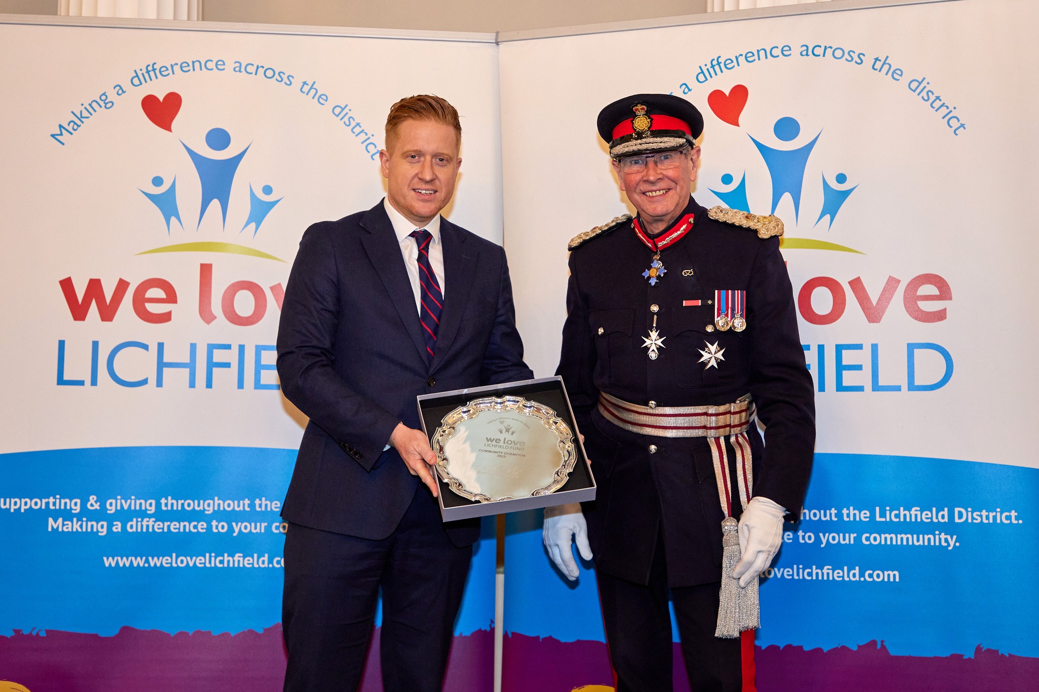 A picture of the Leader of Lichfield District Council, Councillor Doug Pullen, receiving the award on behalf of Lichfield District Council from The Lord Lieutenant of Staffordshire, Ian Dudson.