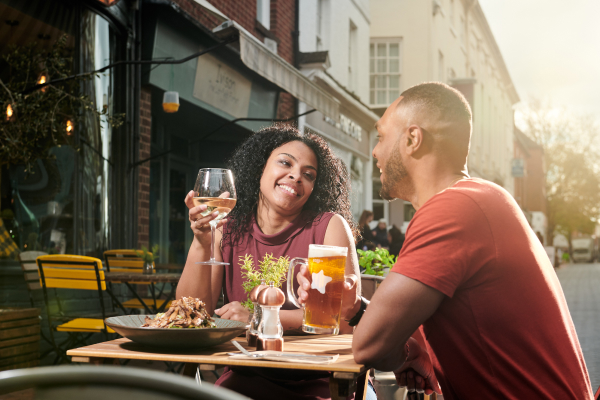 Two people eating outside