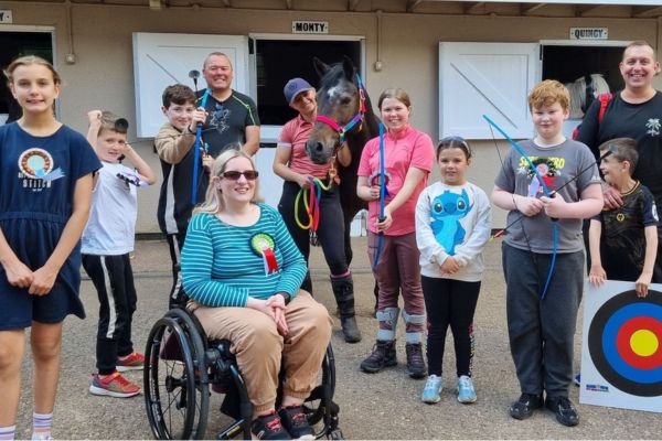 A picture of participants at Gartmore Riding School Riding for the Disabled Group enjoying an archery session.