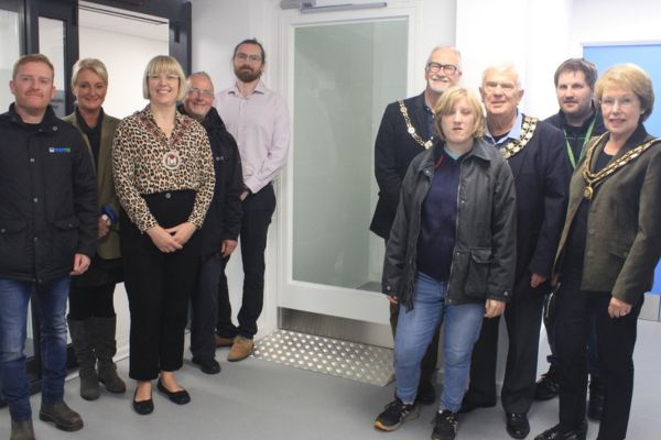 A picture of Invited guests from Lichfield District Council and Lichfield City Council with representatives of Liberty Jamboree inspecting the lift which has been installed at the organisation’s new headquarters on Eastern Avenue.