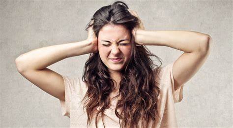 Woman covering her ears with her hands