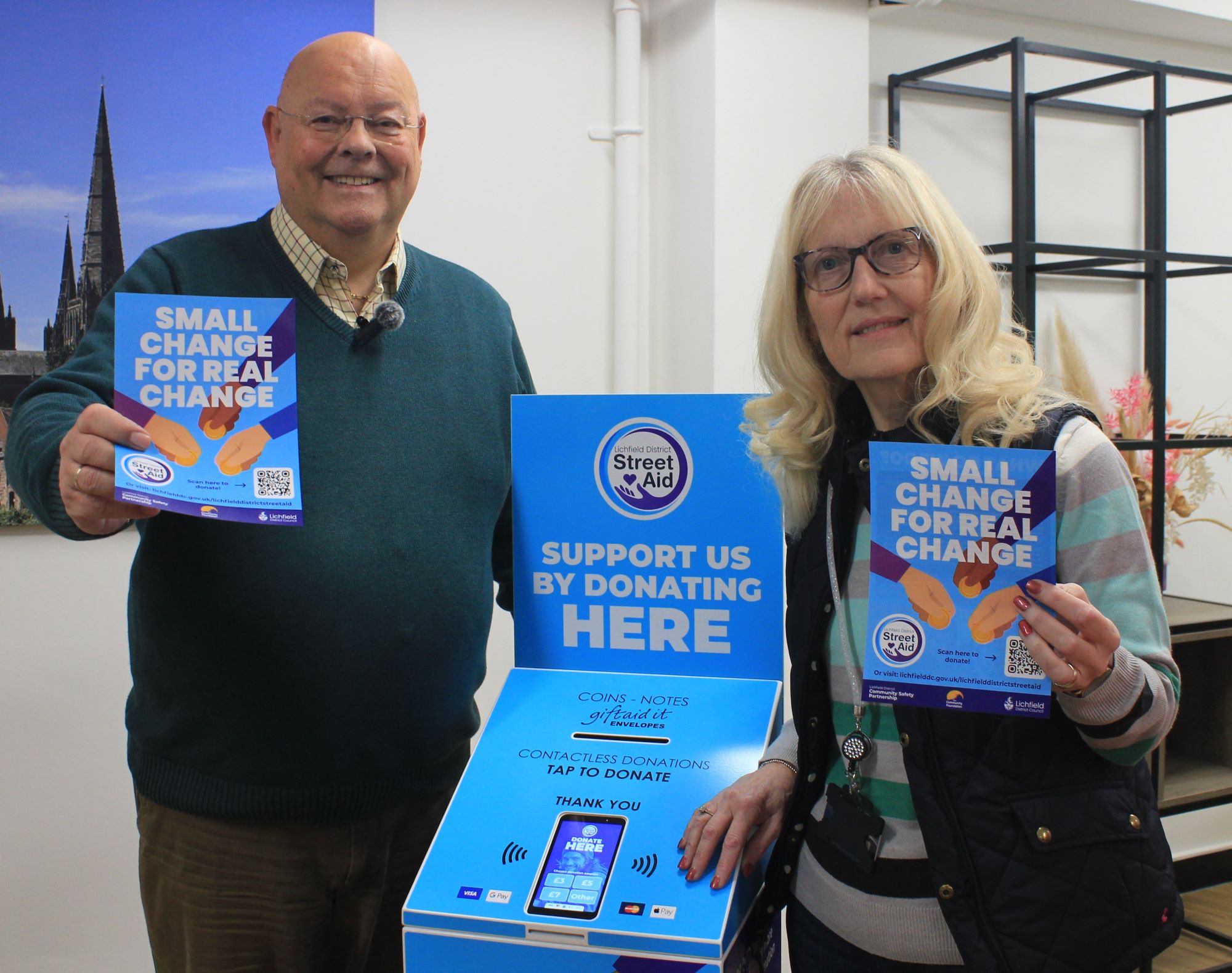 A picture of Lichfield District Council’s Cabinet Member for Community Engagement, Councillor Richard Cox and Lichfield District Council’s Housing and Homelessness Manager Ann Mills with a Street Aid donation point.