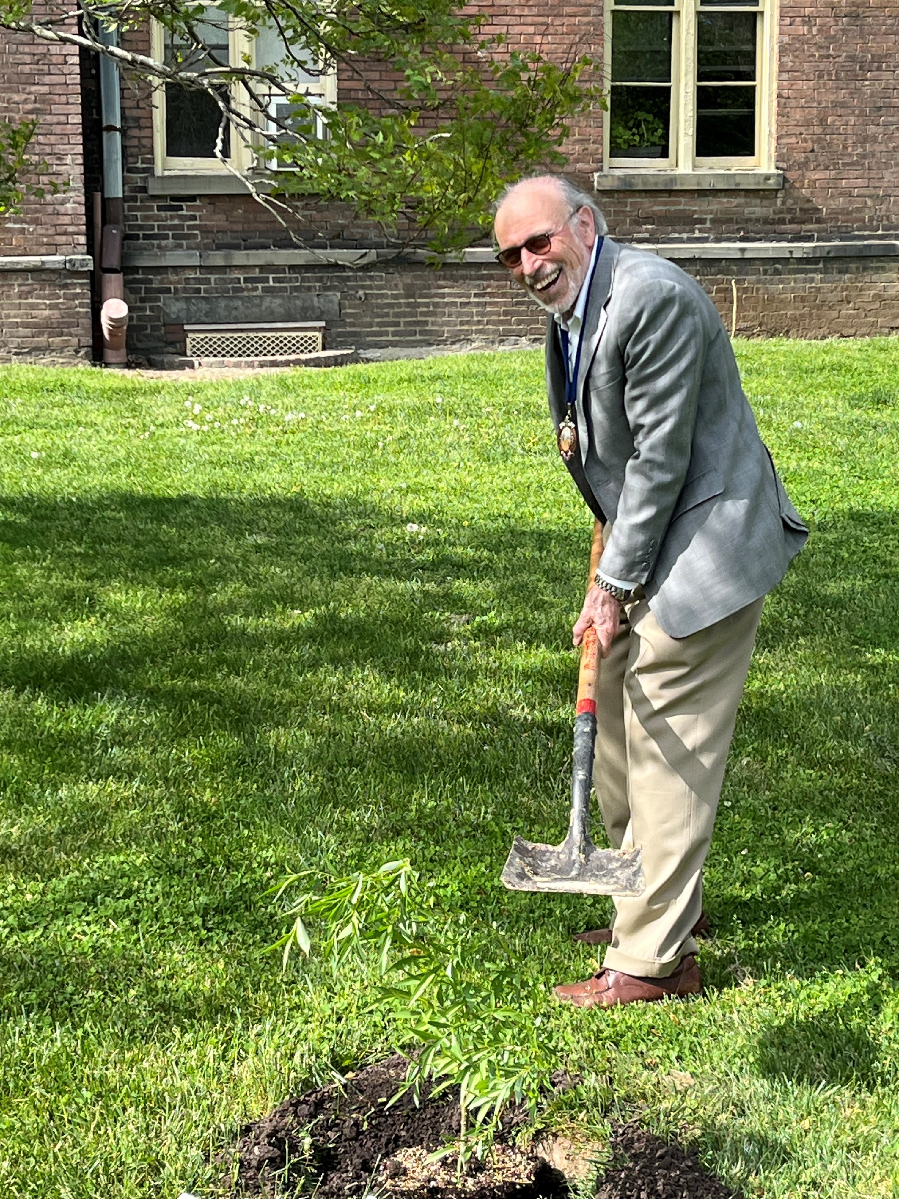 A photo of Robert DeMaria, Jr, Professor of English at Vassar College and scholar on the life and works of Samuel Johnson, planting a cutting.