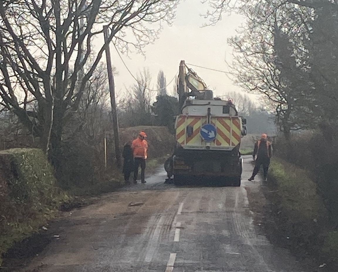 A picture of a roadsweeper cleaning up after the fly-tipped waste was removed.