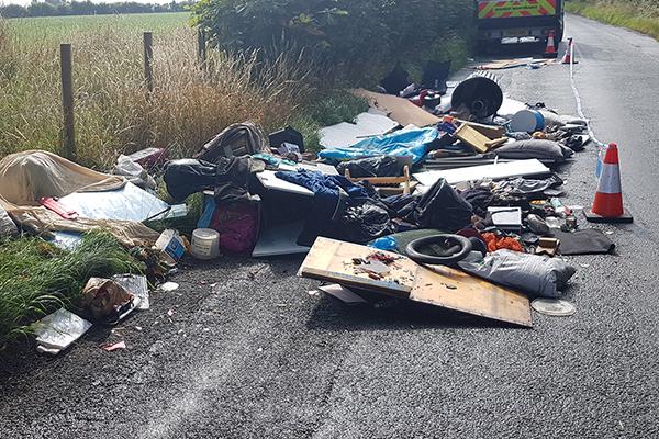 image of waste dumped on the side of a road