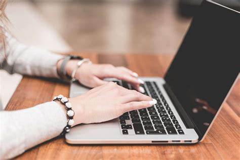 a person typing on a laptop